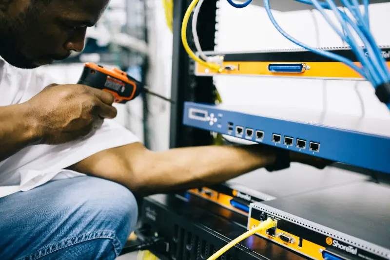 Technician working with network hardware